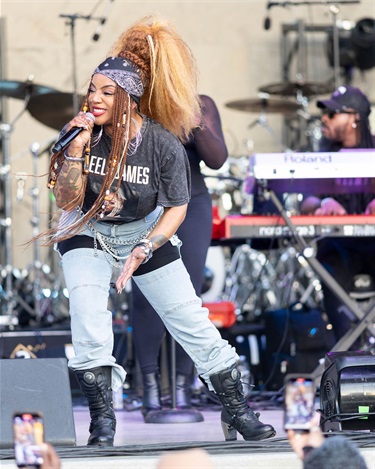 Leela James on stage with key player in background