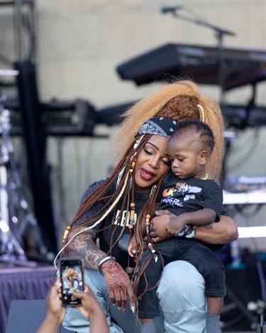 Leela James loves on a baby from the audience
